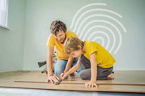 Modern home renovation interior with construction workers installing new kitchen cabinets and countertops in bright contemporary space